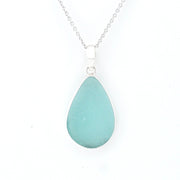 Teardrop-shaped light blue pendant on a silver chain against a white background