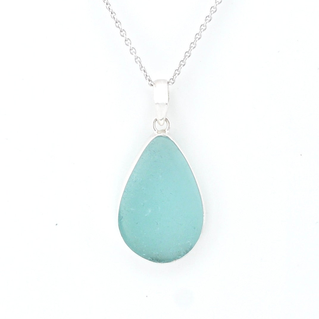 Teardrop-shaped light blue pendant on a silver chain against a white background