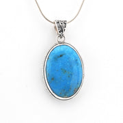 Blue stone pendant on a white background