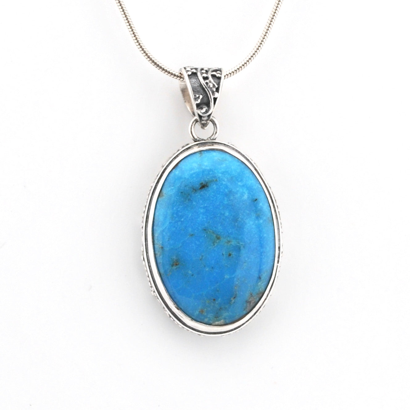 Blue stone pendant on a white background