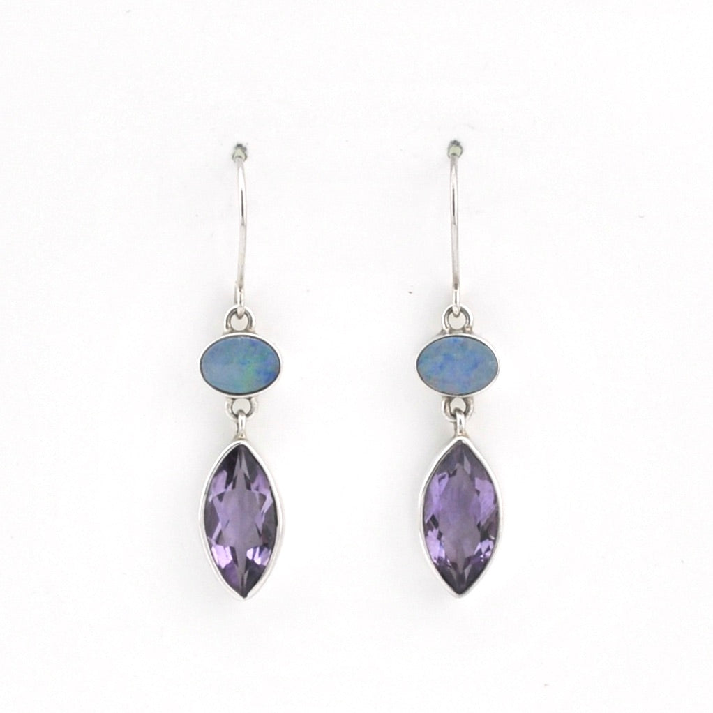 Pair of earrings with marquise-shaped purple stones and smaller round stones on a white background