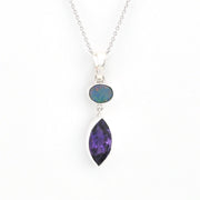 Necklace with a purple teardrop pendant and black opal stone on a white background