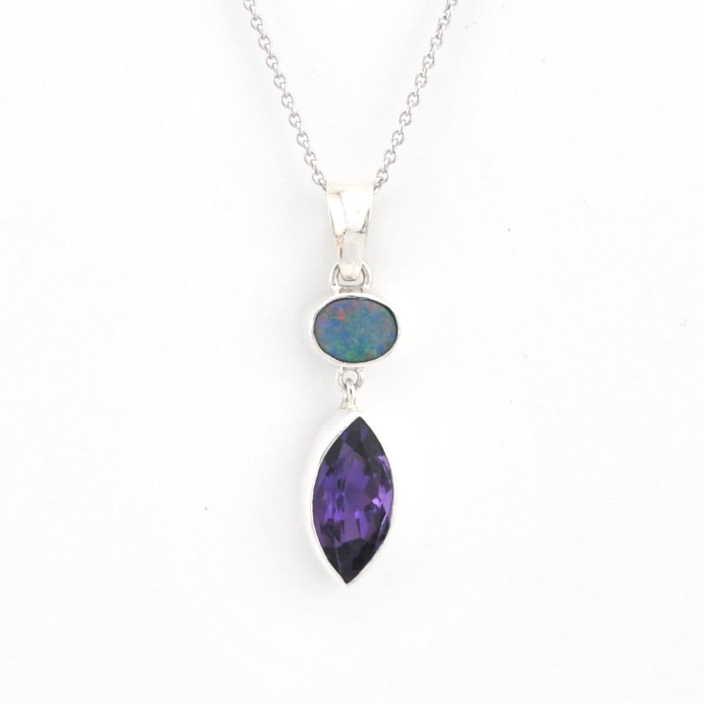 Necklace with a purple teardrop pendant and black opal stone on a white background