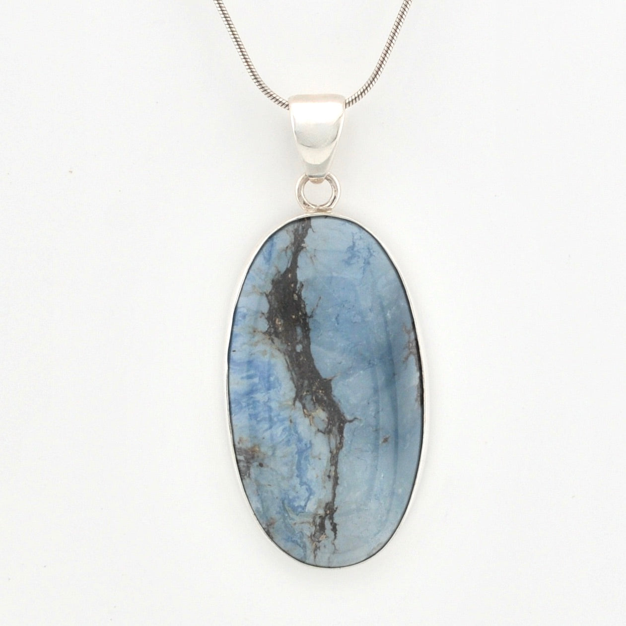 Oval-shaped blue stone pendant on a silver chain against a white background