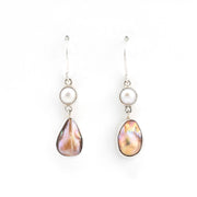 Pair of earrings with teardrop-shaped pearls on a white background