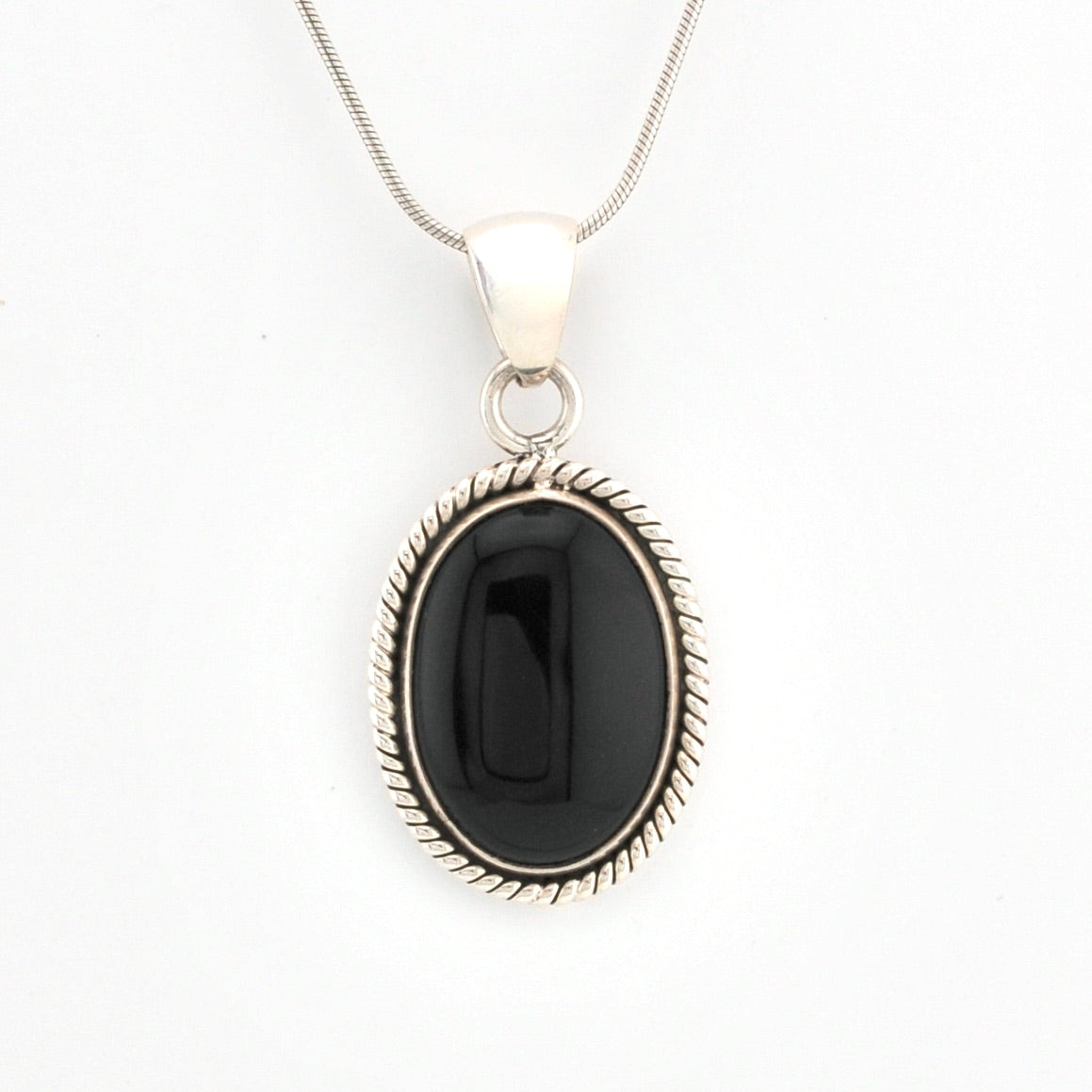 Black pendant necklace on a white background