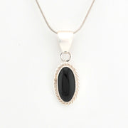 Silver pendant with a black stone on a white background