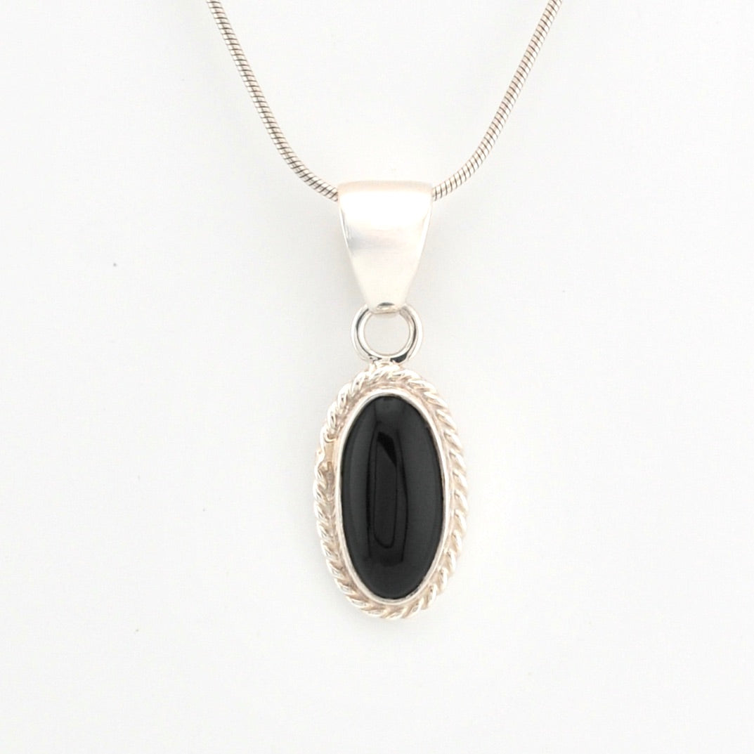 Silver pendant with a black stone on a white background