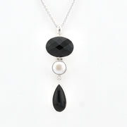 Necklace with black and white pendant on a white background