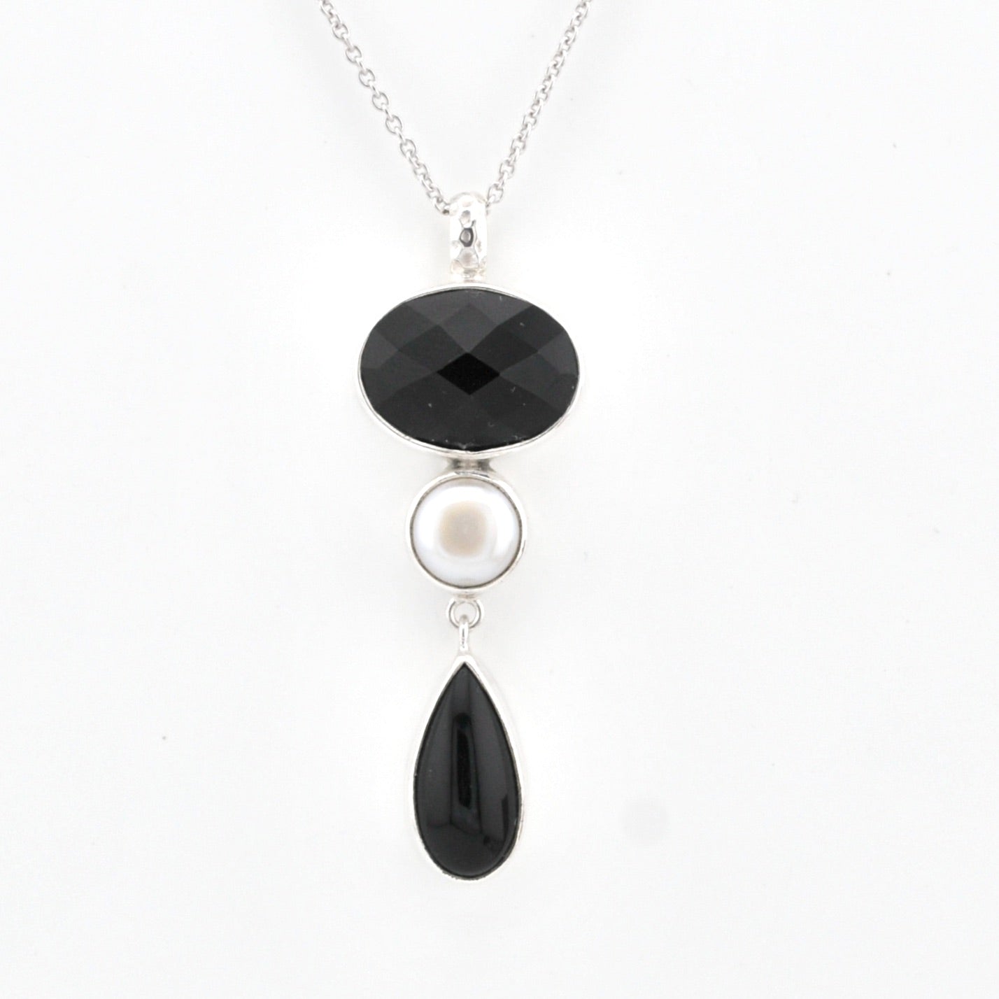 Necklace with black and white pendant on a white background