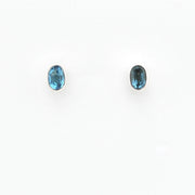 Pair of blue gemstone stud earrings on a white background