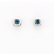 Pair of blue gemstone stud earrings on a white background