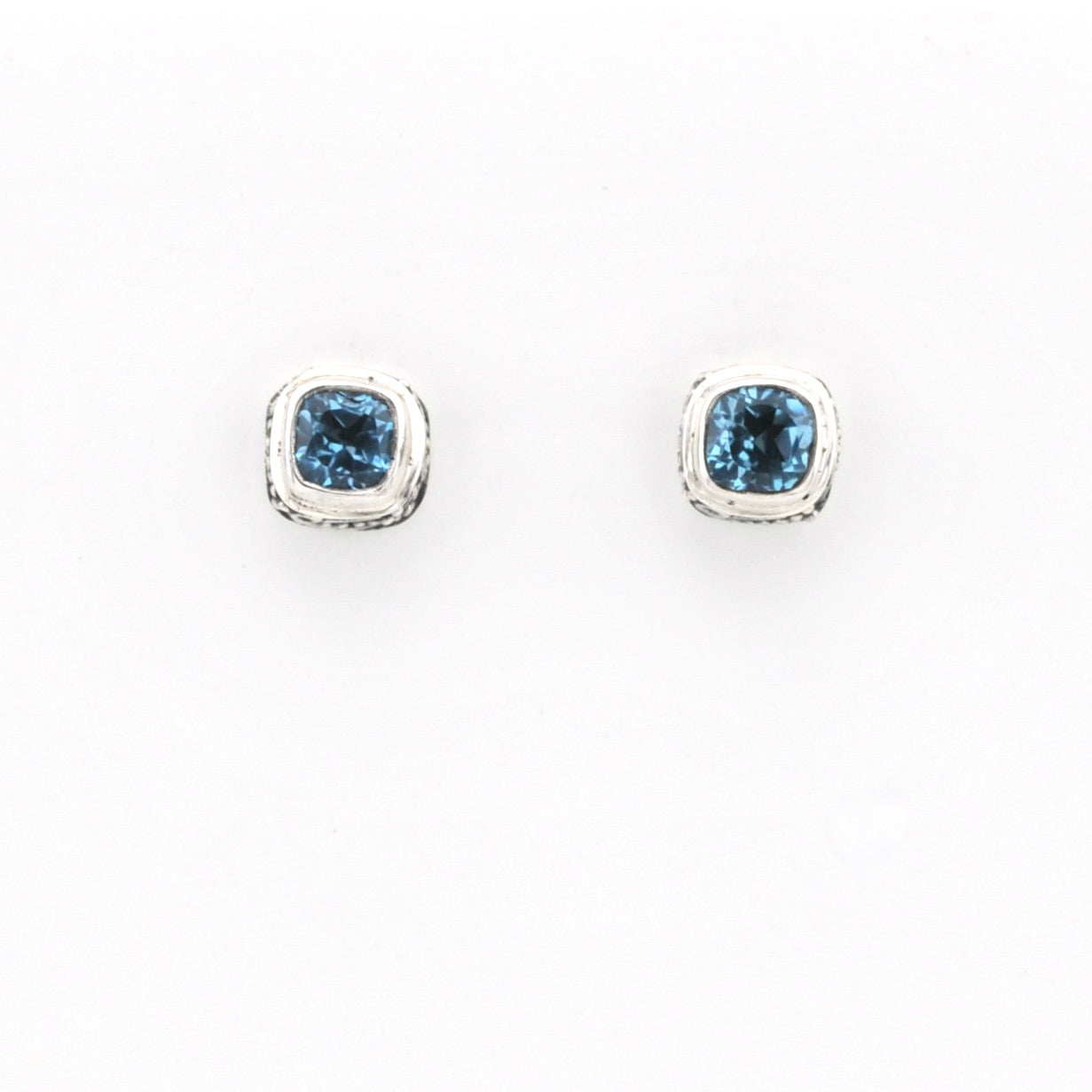 Pair of blue gemstone stud earrings on a white background