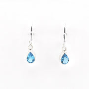 Pair of teardrop-shaped blue gemstone earrings on a white background