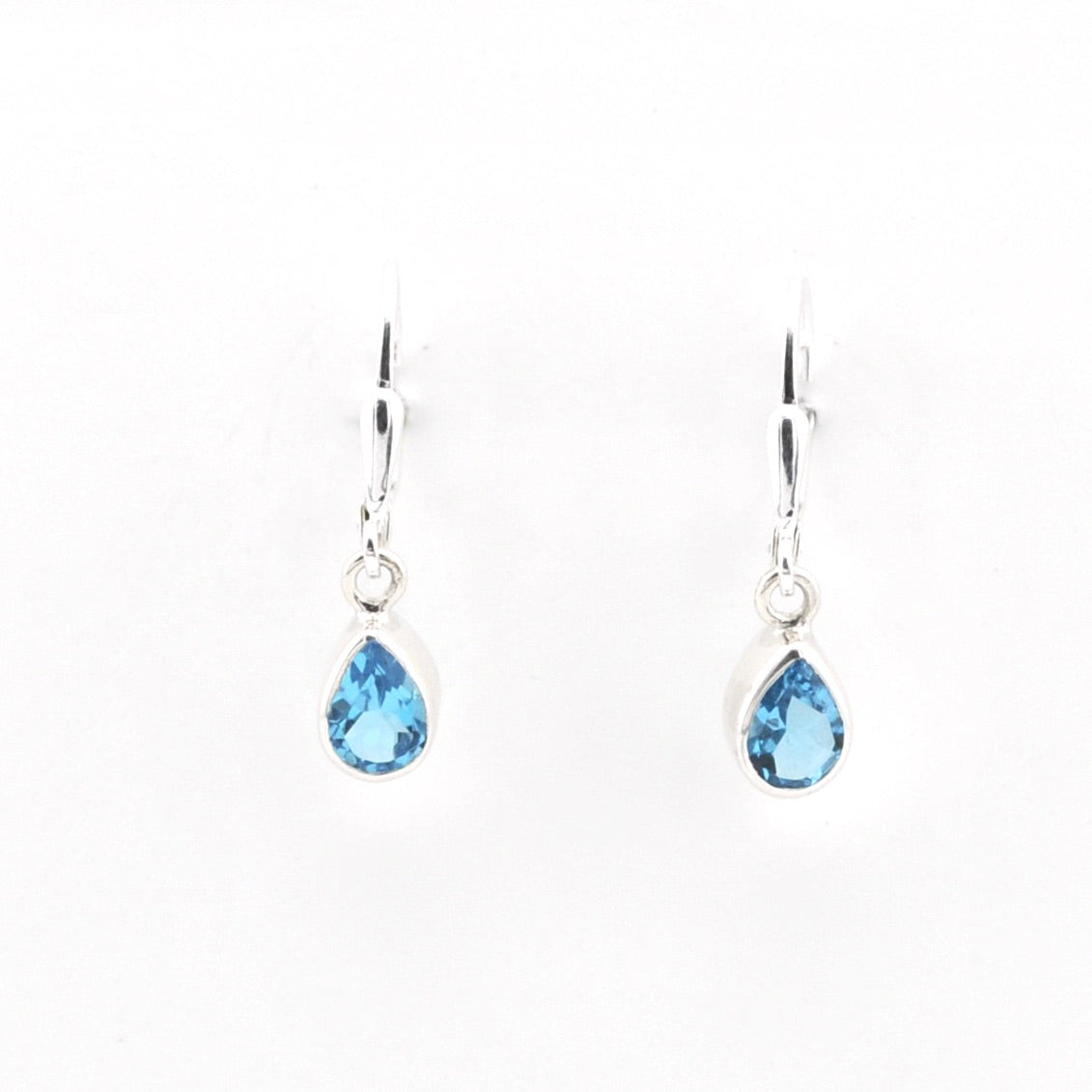 Pair of teardrop-shaped blue gemstone earrings on a white background