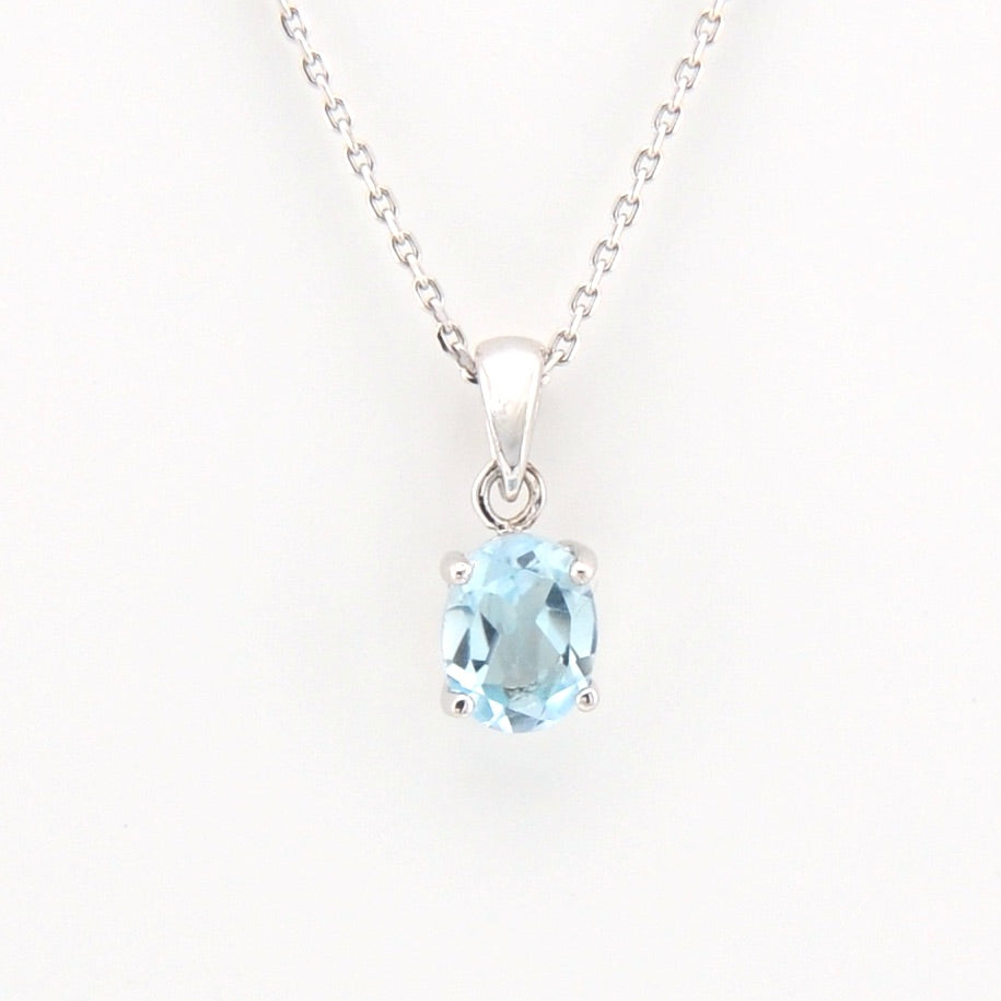 Silver necklace with a blue gemstone pendant on a white background