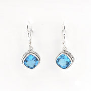 Pair of earrings with blue gemstones on a white background