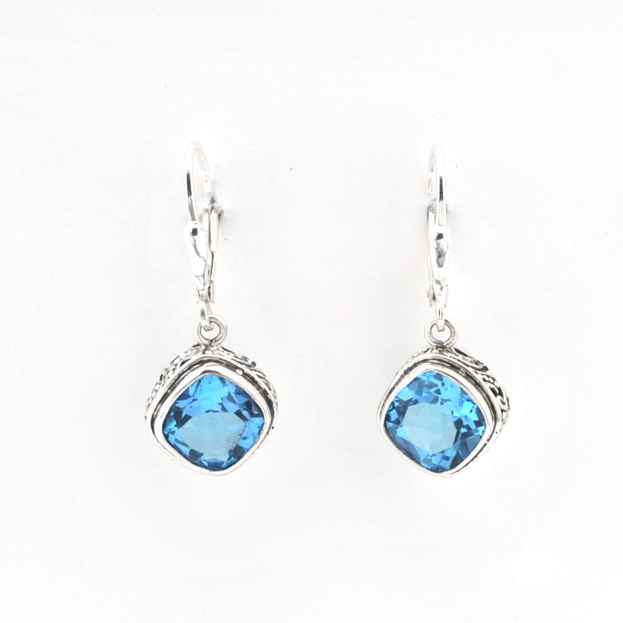 Pair of earrings with blue gemstones on a white background