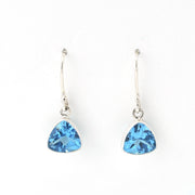 Pair of silver earrings with blue triangular gemstones on a white background