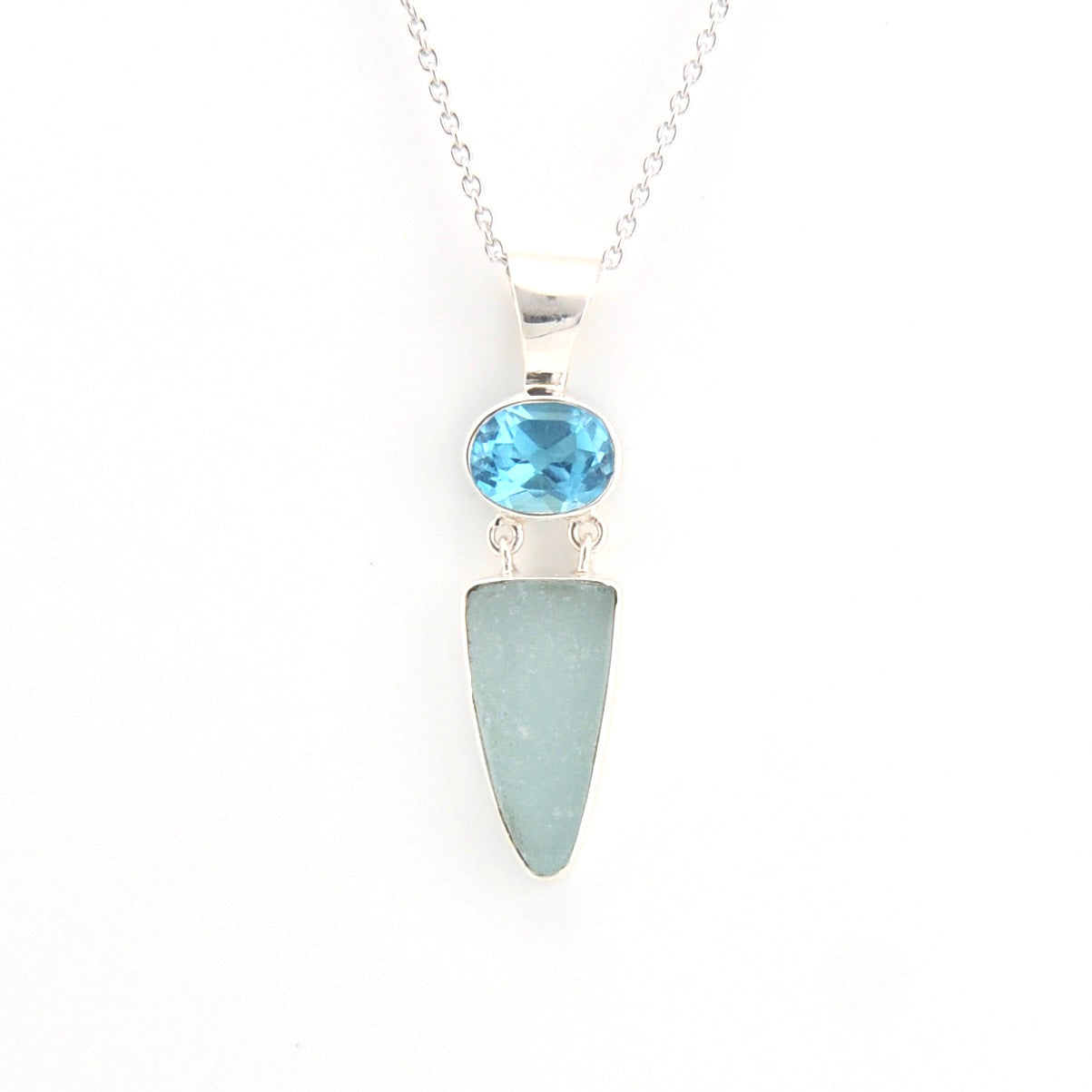 Necklace with a blue gemstone and light blue pendant on a white background