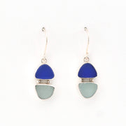 Pair of earrings with blue and green triangular stones on a white background