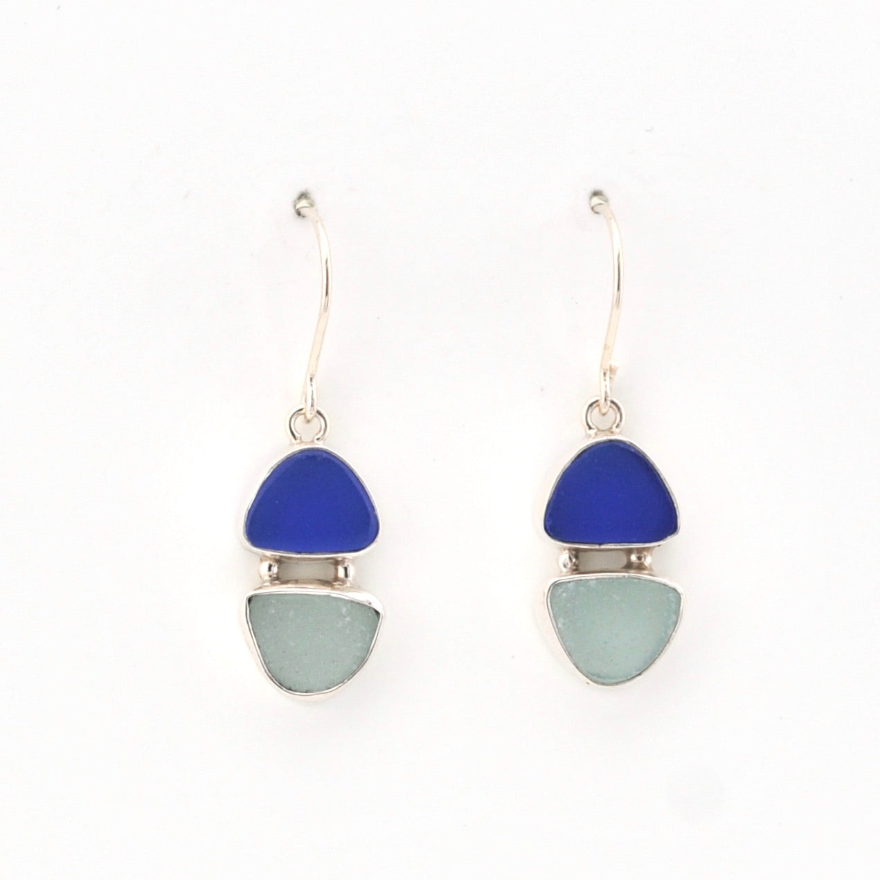 Pair of earrings with blue and green triangular stones on a white background