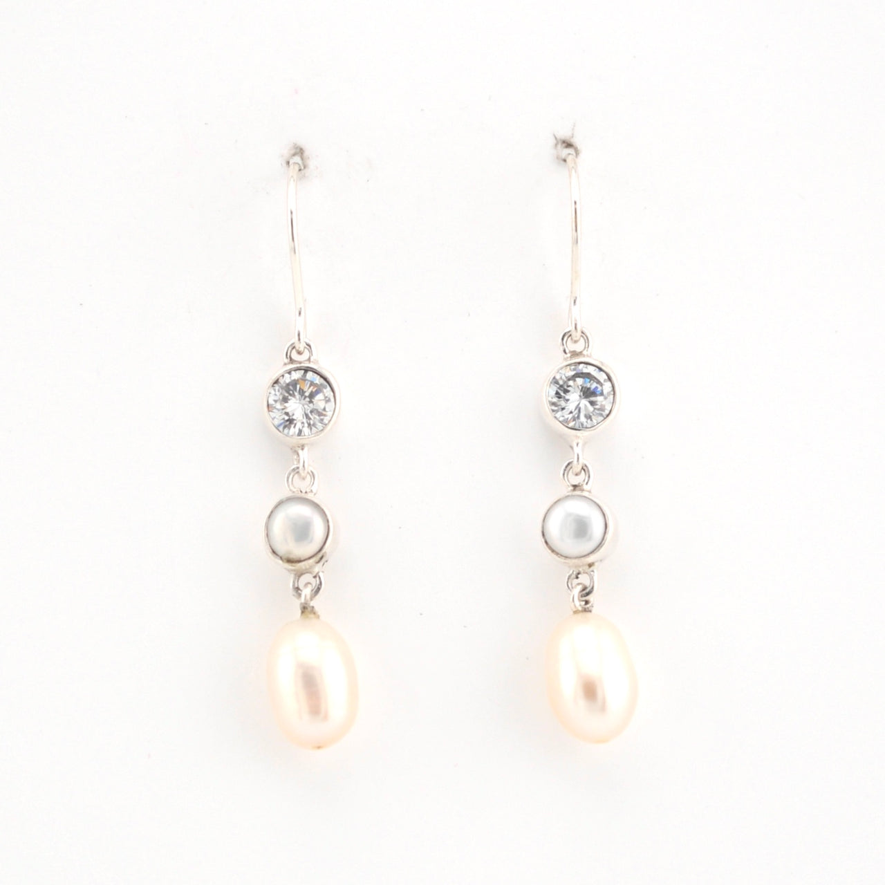 Pair of pearl and crystal drop earrings on a white background