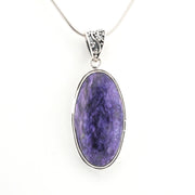 Purple stone pendant on a silver chain against a white background