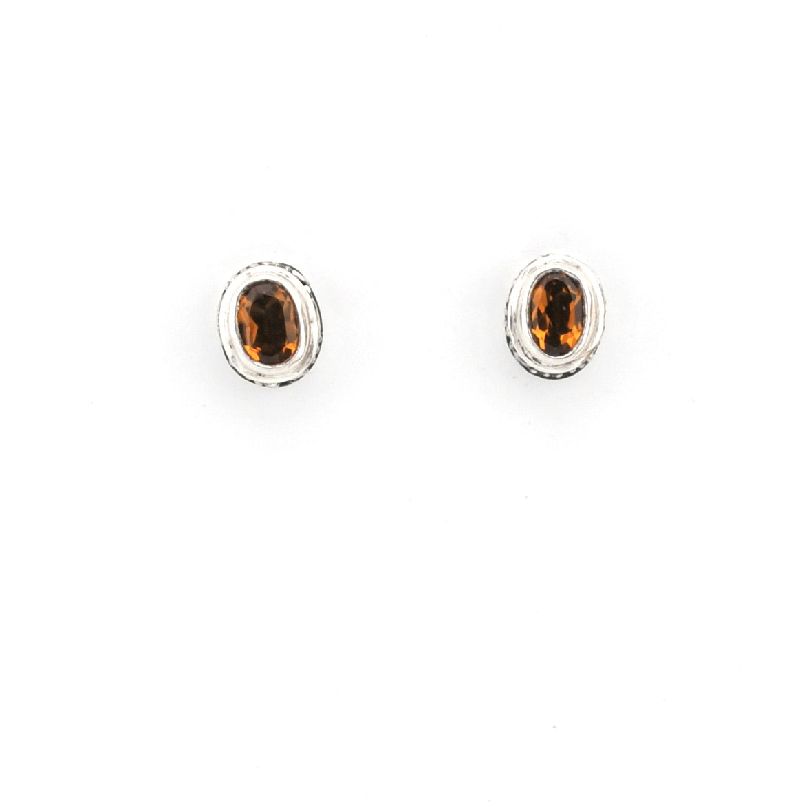 Pair of silver earrings with brown gemstones on a white background