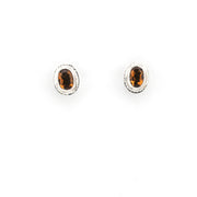 Pair of silver earrings with brown gemstones on a white background