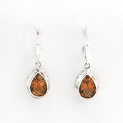 A pair of silver leverback drop earrings featuring teardrop-shaped orange gemstones in a silver bezel setting, shown against a plain white background.