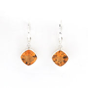 A pair of silver leverback earrings featuring cushion-cut orange citrine gemstones in bezel settings, shown against a plain white background.