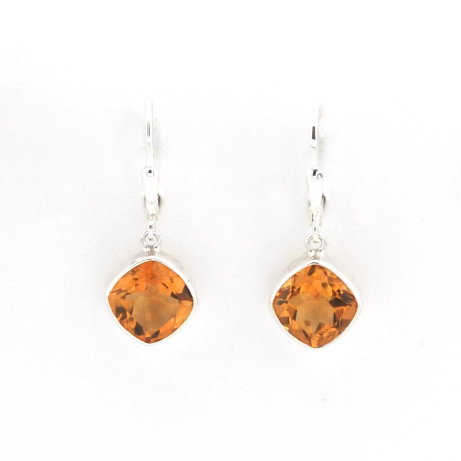 A pair of silver leverback earrings featuring cushion-cut orange citrine gemstones in bezel settings, shown against a plain white background.