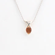 Silver necklace with a marquise-shaped pendant on a white background