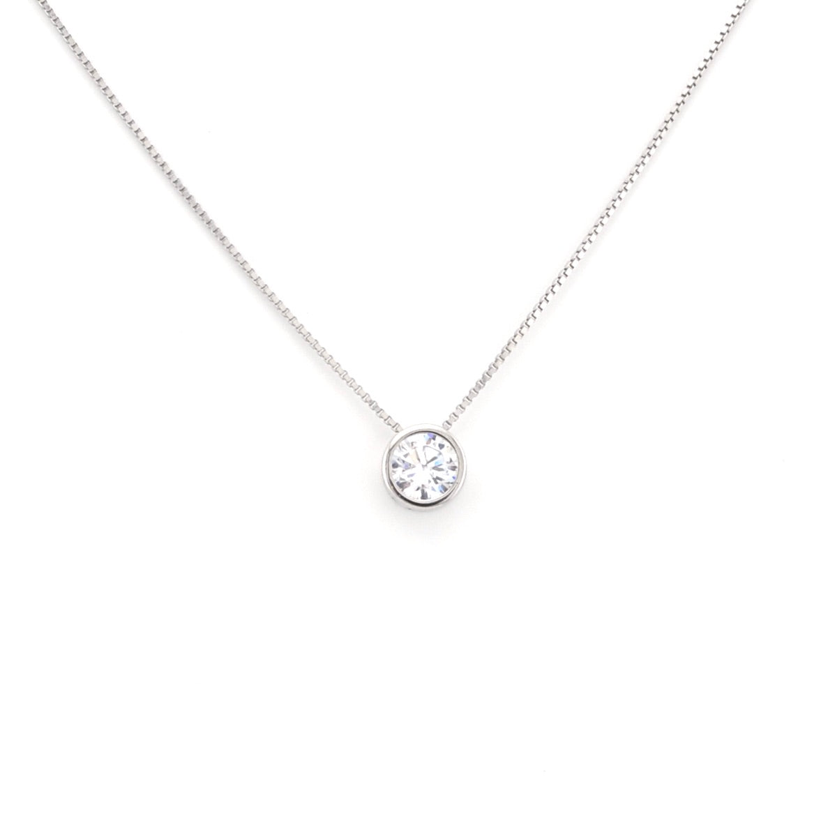 Silver necklace with a round pendant on a white background