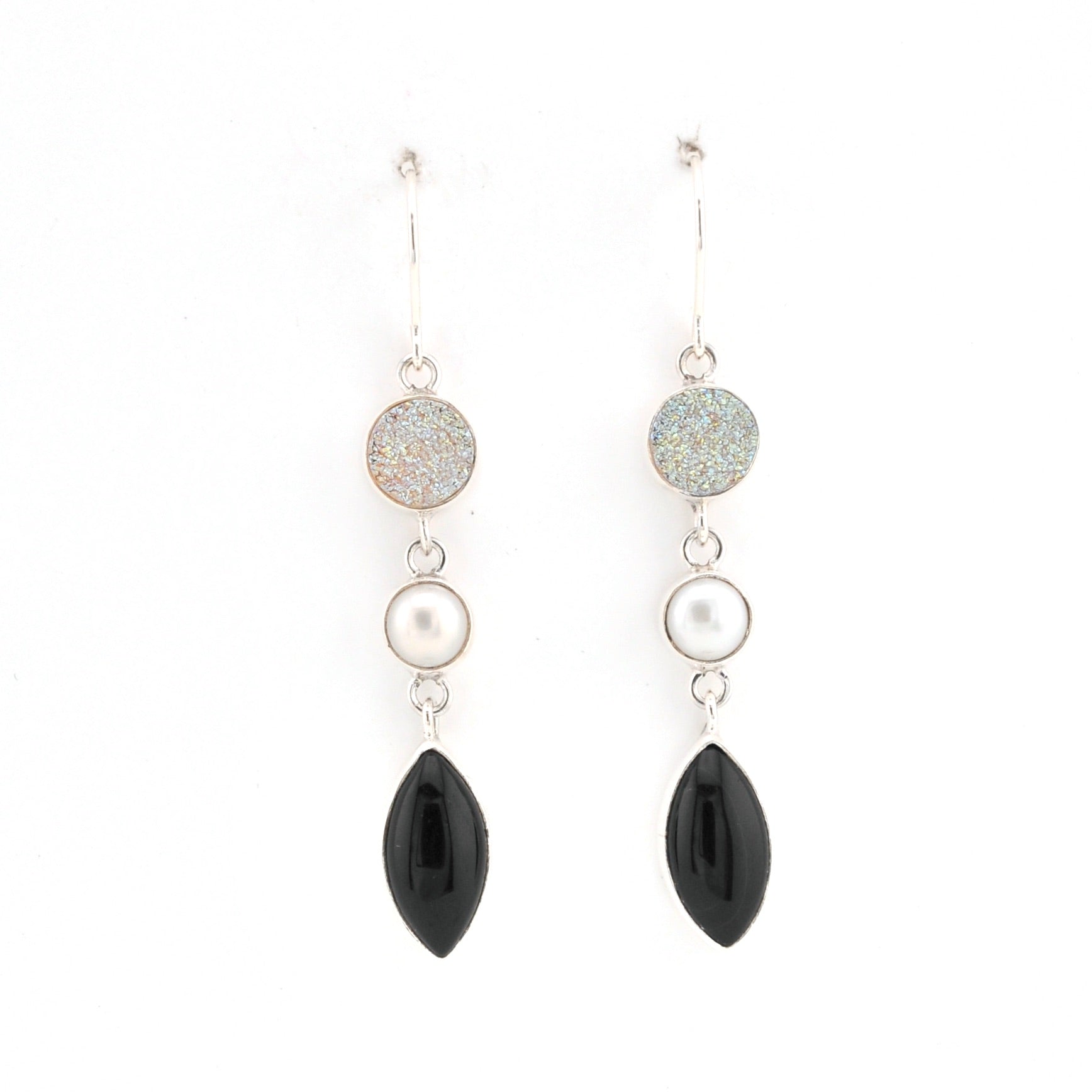 Pair of earrings with black and pearl-like stones on a white background