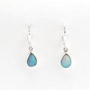 Teardrop-shaped opal earrings on a white background