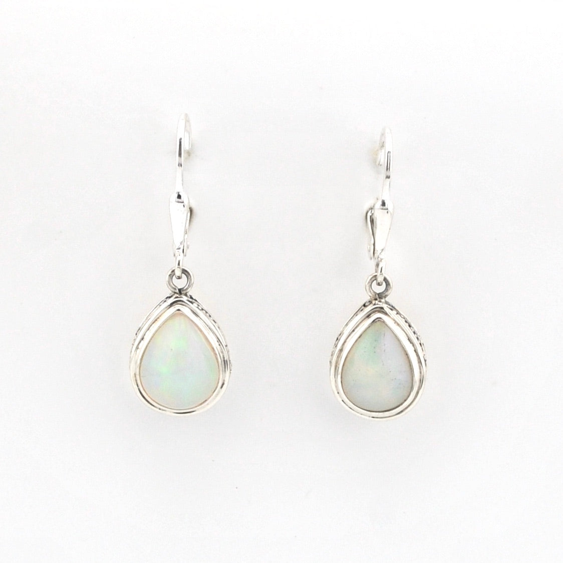 Teardrop-shaped earrings with light-colored gemstones on a white background
