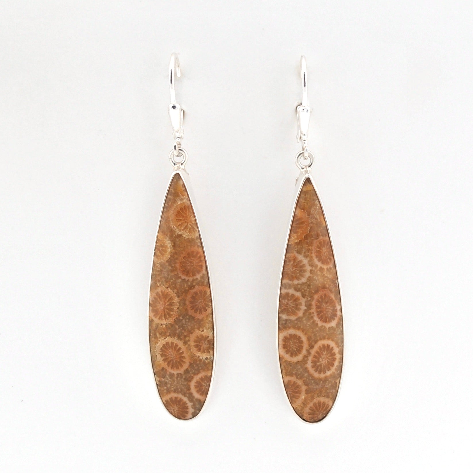 Pair of earrings with brown floral patterns on a white background