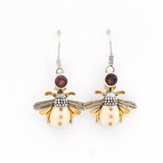 Bee-shaped earrings with gold and silver details on a white background