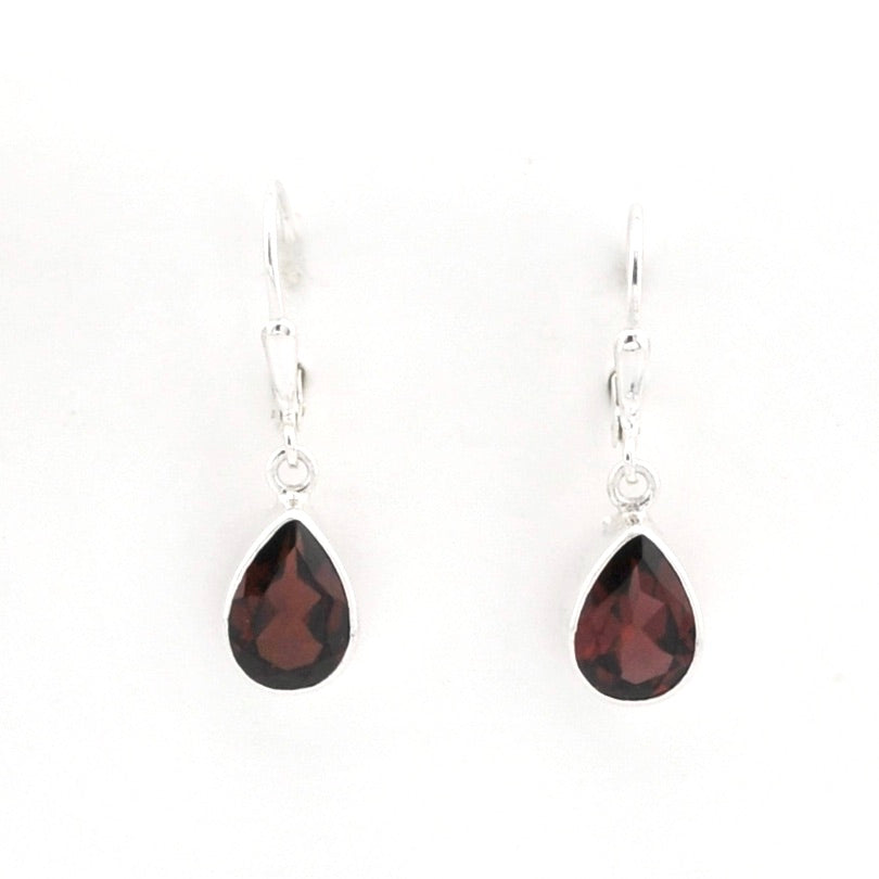 A pair of silver leverback drop earrings featuring faceted teardrop-shaped dark red garnet gemstones, shown against a plain white background.