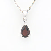 Teardrop-shaped gemstone pendant on a white background