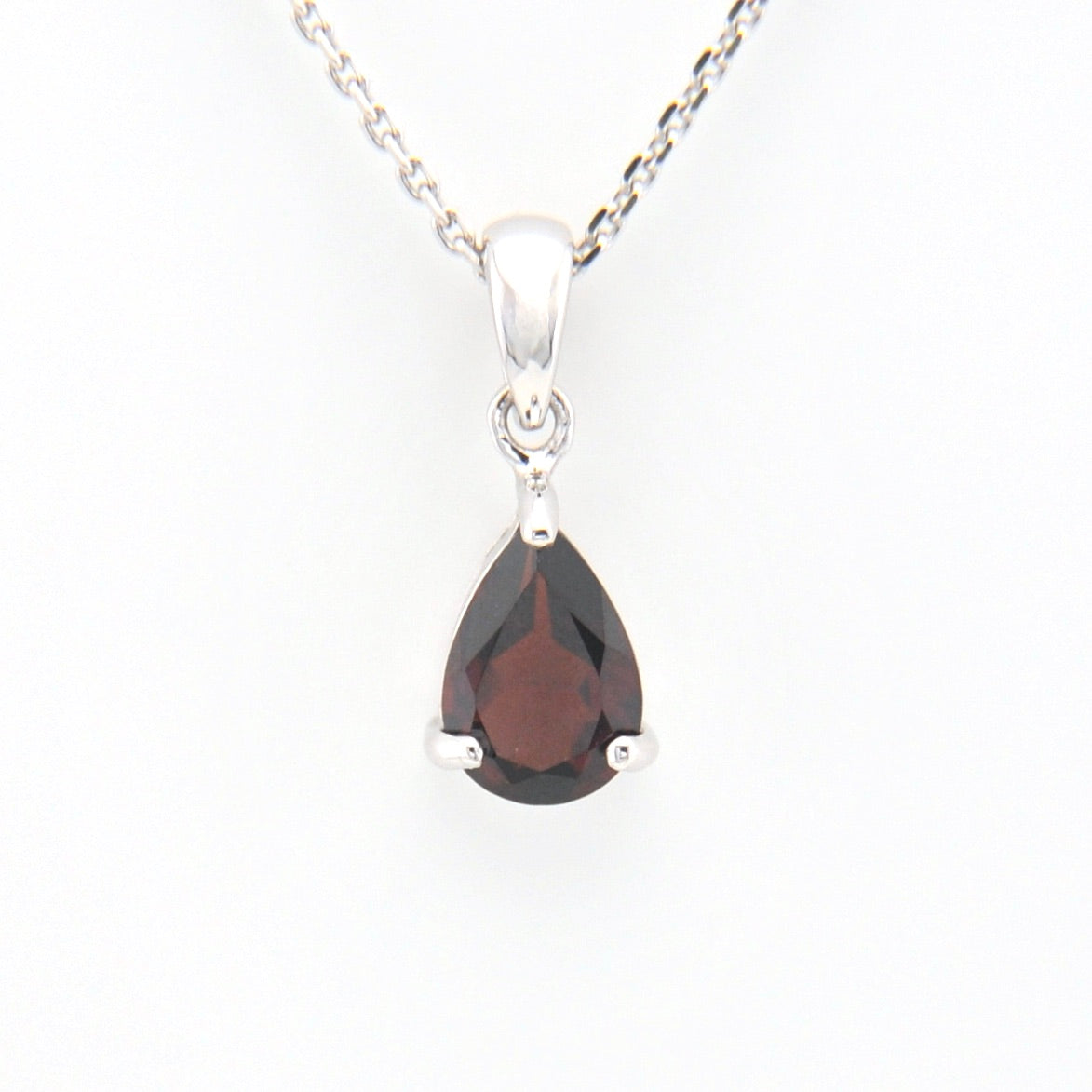 Teardrop-shaped gemstone pendant on a white background