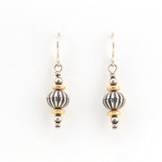 Pair of silver and gold beaded earrings on a white background