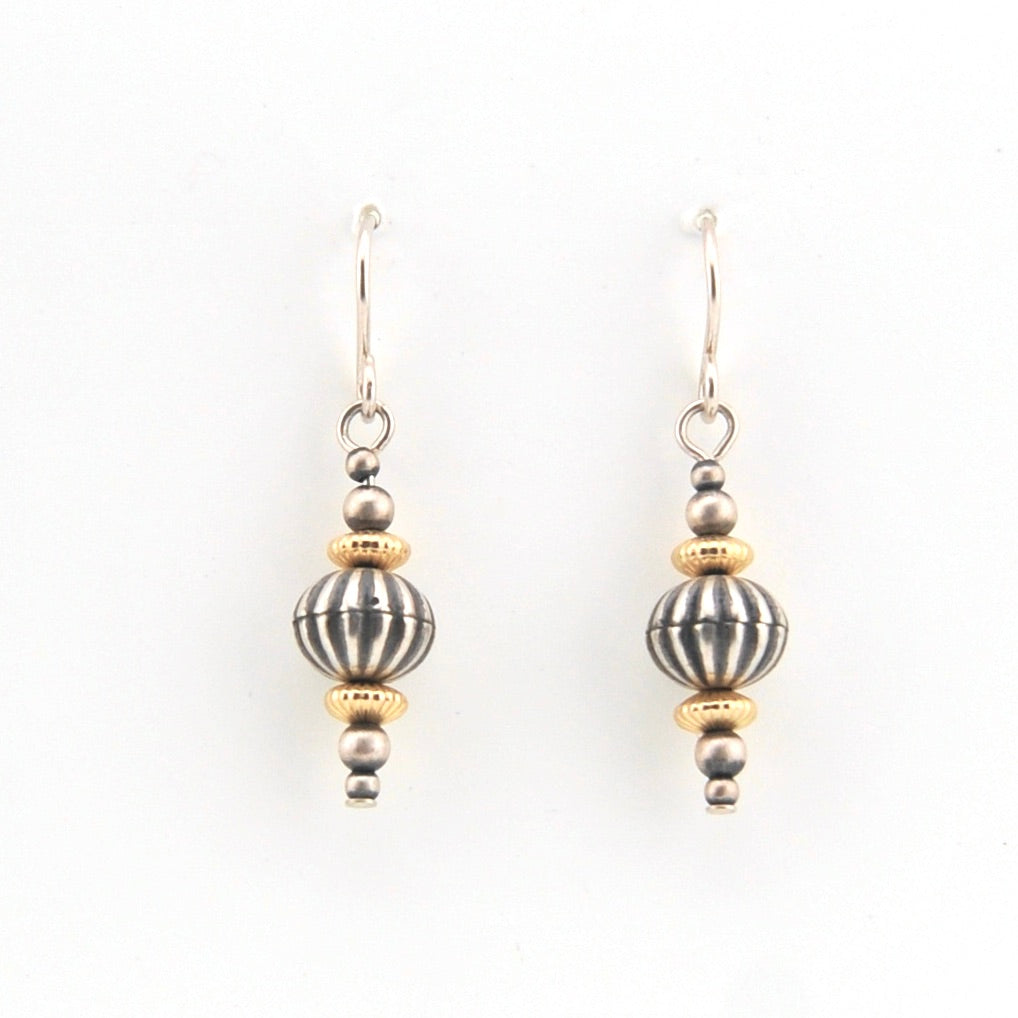 Pair of silver and gold beaded earrings on a white background