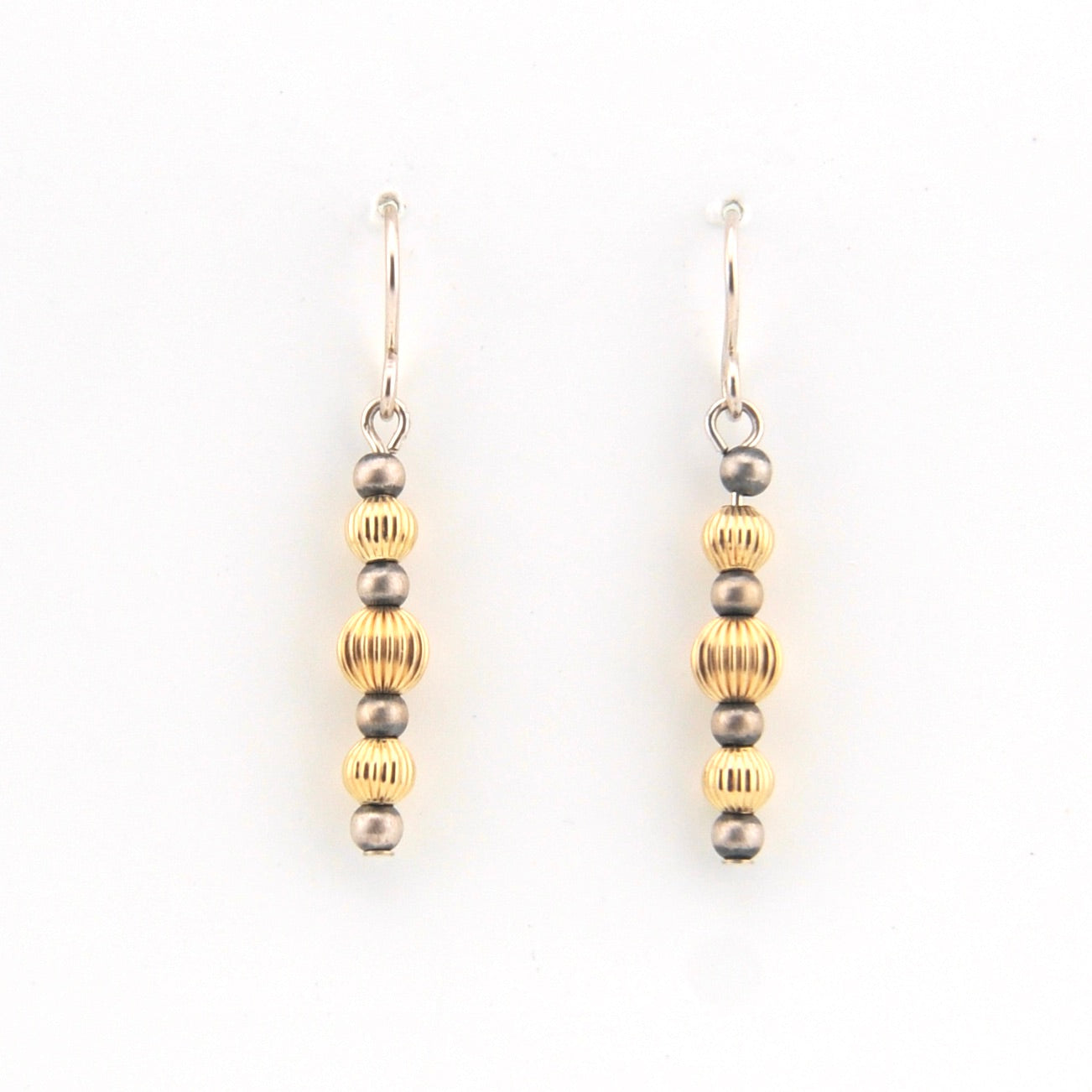 Pair of earrings with alternating gold and silver beads on a white background