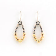 Pair of hoop earrings with gold and silver beads on a white background