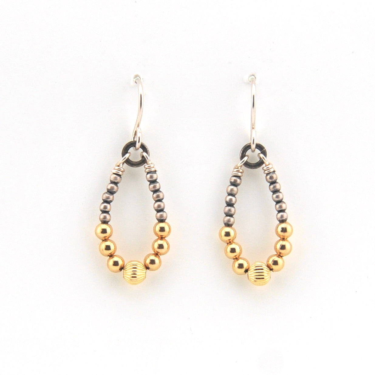 Pair of hoop earrings with gold and silver beads on a white background