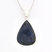 Teardrop-shaped blue pendant on a white background