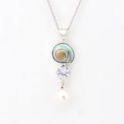 Necklace with a shell pendant, cz, and pearl on a white background
